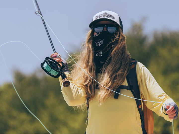 Woman wears Heron Ocean Cat. 3 polarized side shield sunglasses from VALLON while sea fishing in the Maldives for maximum eye and sun protection