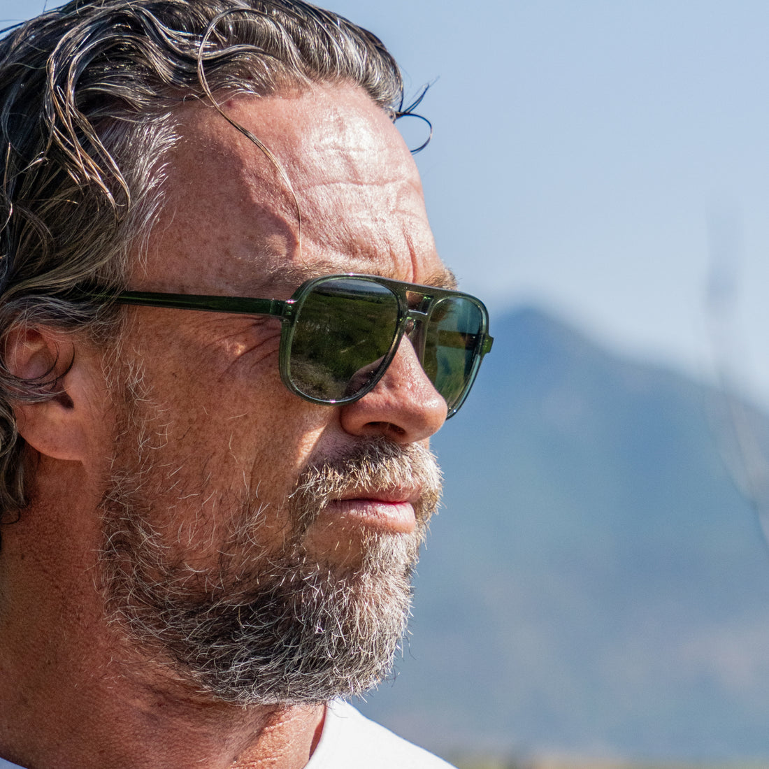 Man wears VALLON Howlin' sunglasses in green