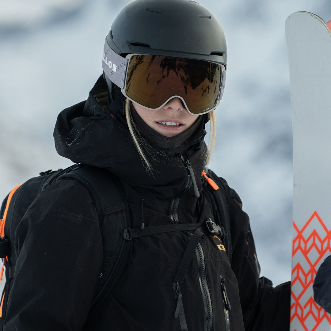 Female skier wears Sand-Copper Crossroads ski goggles from VALLON