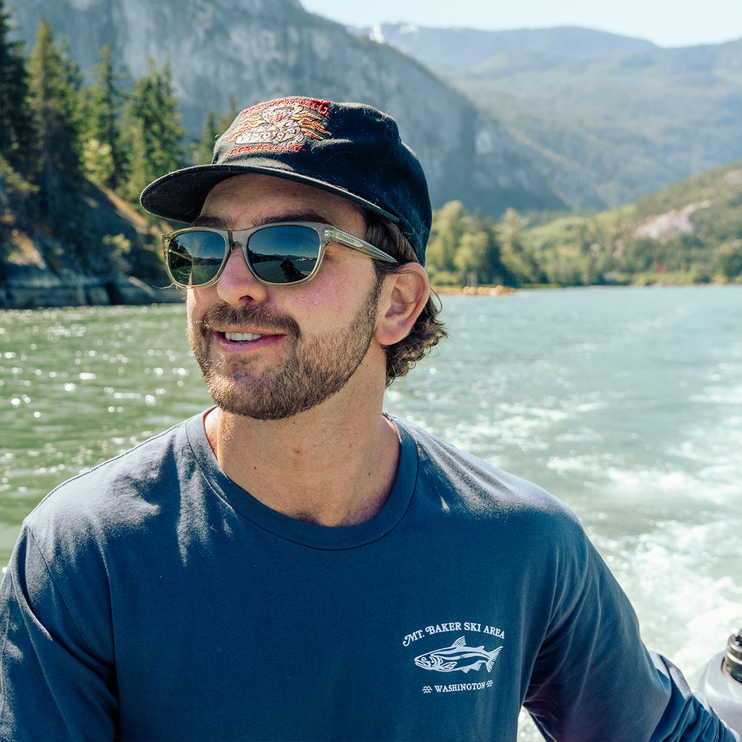 Man on a boat wearing Daytrippers polarized sunglasses from VALLON in Sage