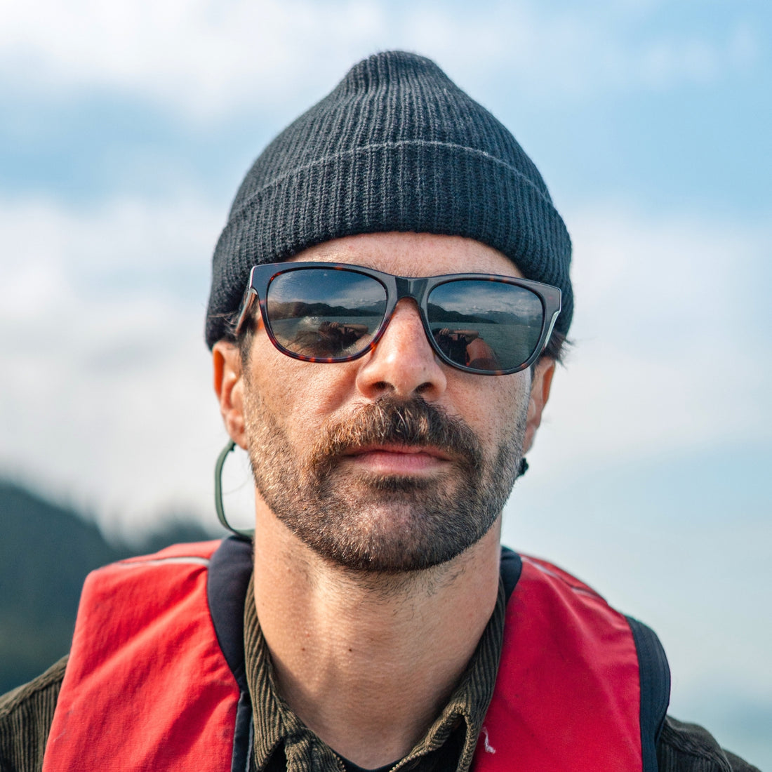 Man on a boat wearing Daytrippers polarized sunglasses from VALLON in Dark Tortoise