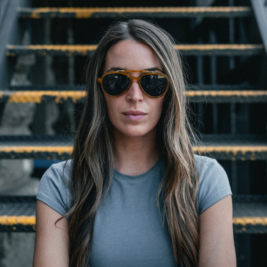 Woman wears Ella Horn polarized brow-bar aviator sunglasses from VALLON