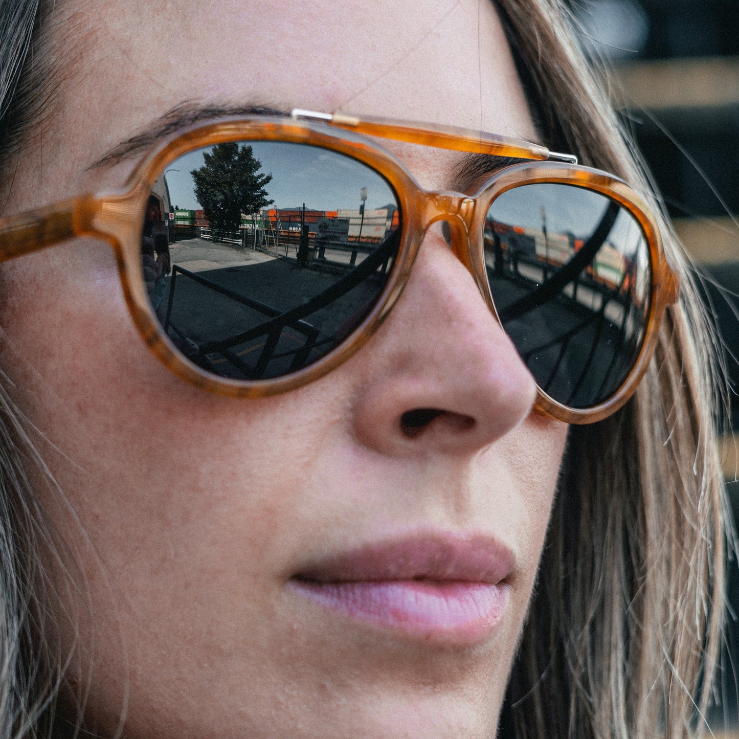 Side view of woman wearing Ella Horn polarized brow-bar aviator sunglasses from VALLON