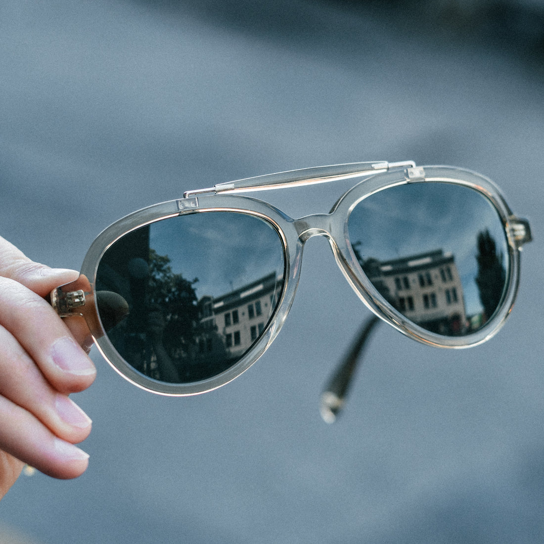 Close-up of VALLON brow-bar aviator sunglasses for women in sage, fitted with polarized V52 lenses