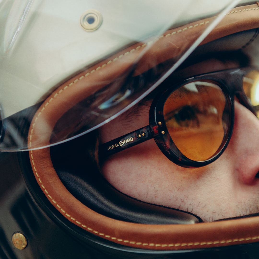 Close up of male motorcyclist wearing Royal Enfield Special Edition Moto Aviators from VALLON in Dark Tortoise-Yellow