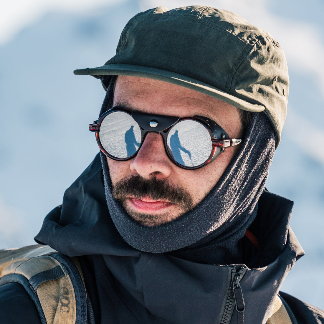 Man wears Heron Glacier sunglasses from VALLON in Tortoise for ski touring