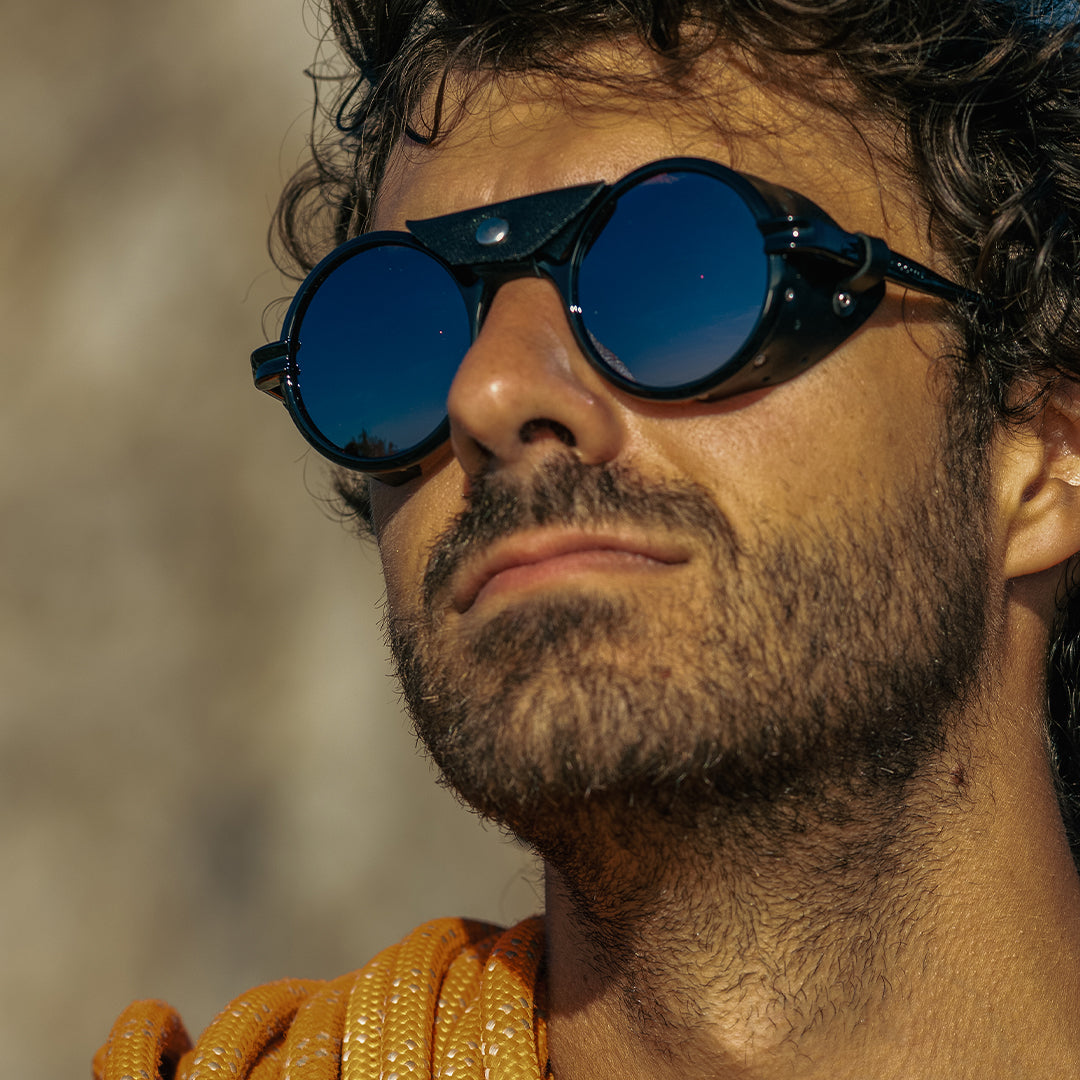 Man wears Heron Mountain Rx sunglasses for climbing