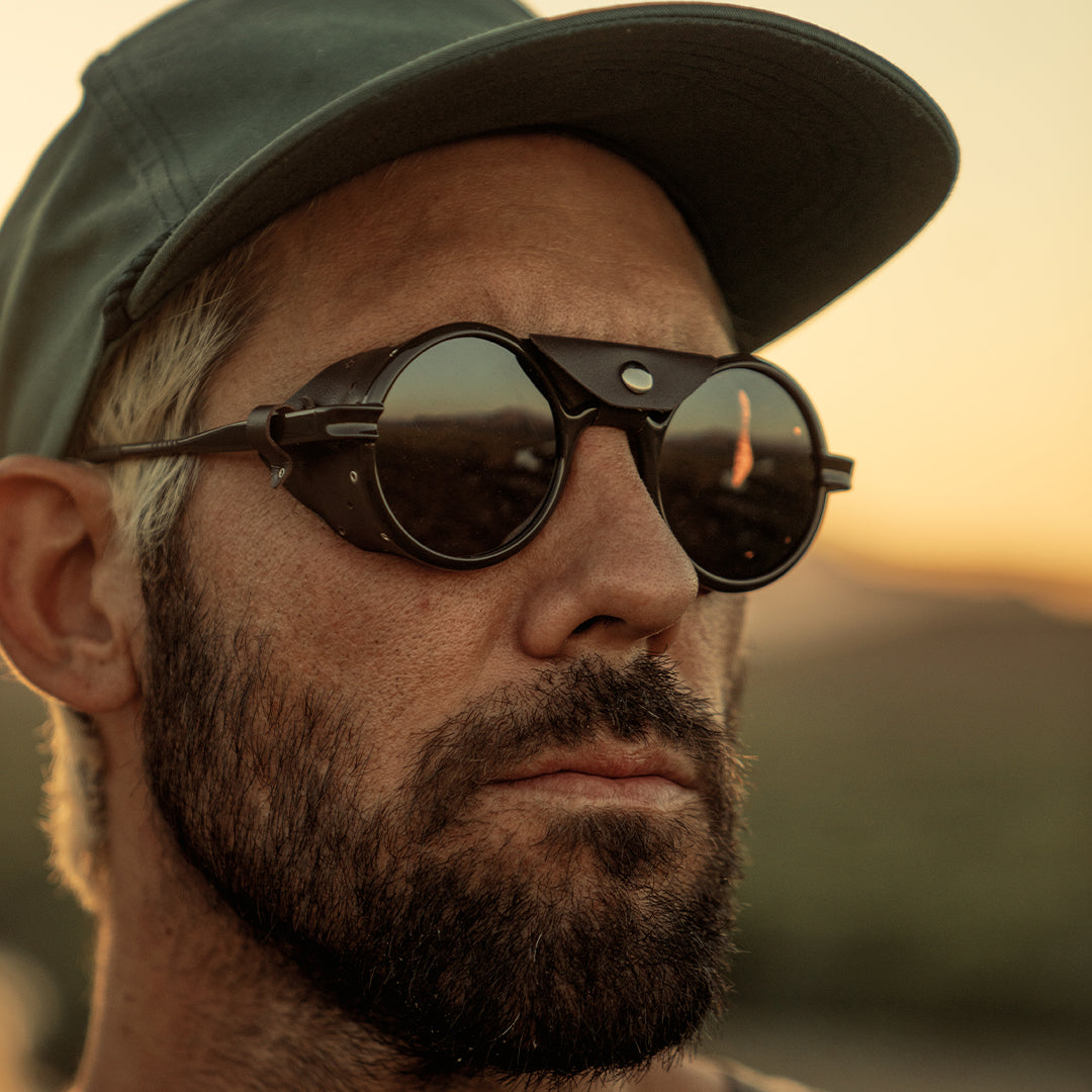 Man wears Heron Mountain side shield mountaineering sunglasses from VALLON