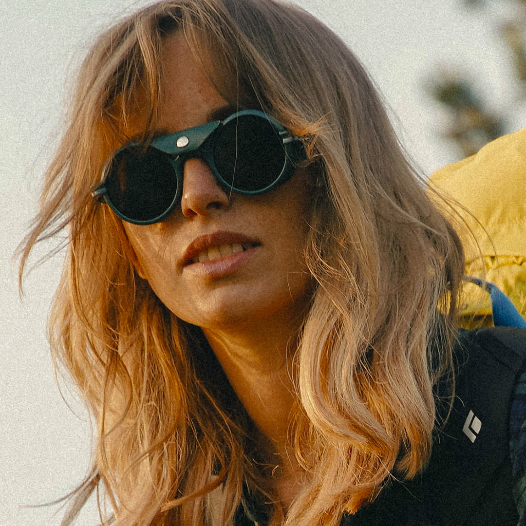 Woman wears VALLON Heron Mountain side shield sunglasses for hiking