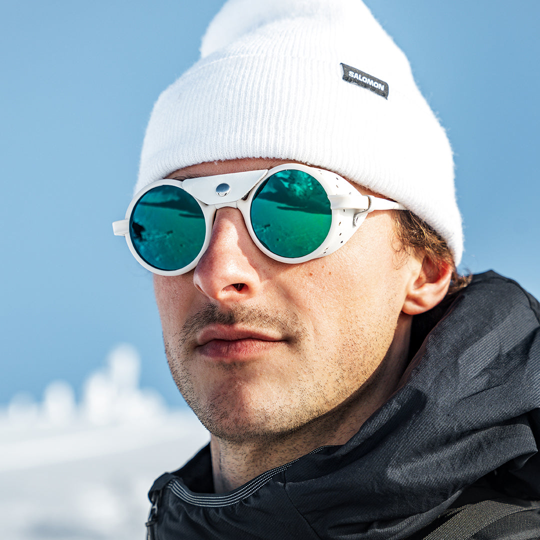 Man wears Off-White-Green Heron Glacier sunglasses with full mirror lenses and Cat. 4 sun protection from VALLON