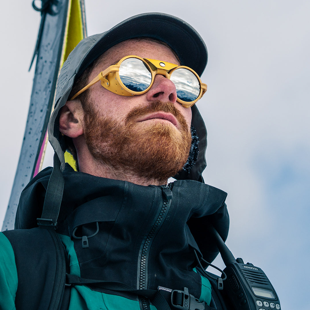 Man wears VALLON Heron Glacier Rx sunglasses for ski touring