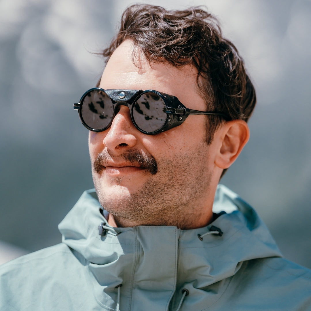 Man wears Cat. 3 Heron Mountain sunglasses from VALLON with side shield protection