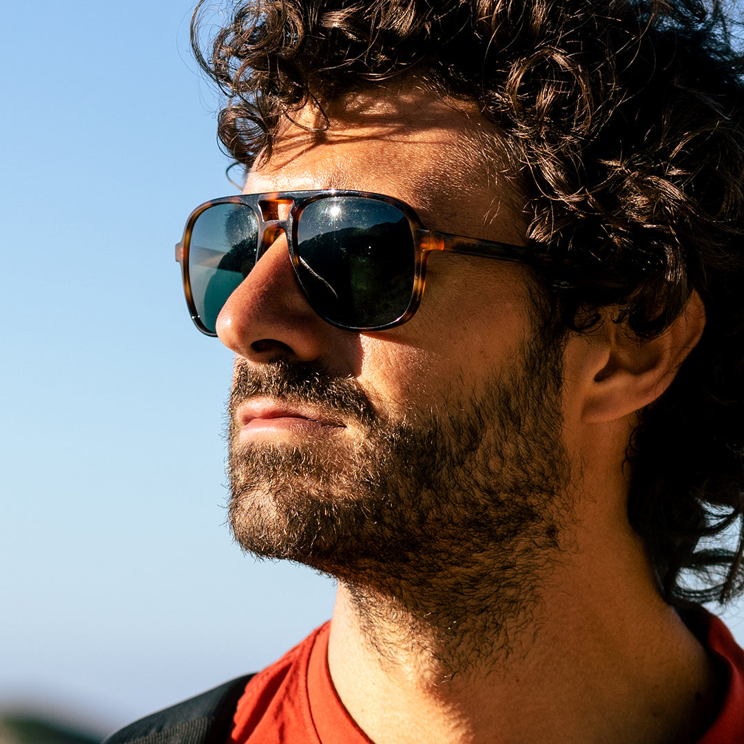 Man wears Howlin' Cat. 3 aviator sunglasses from VALLON
