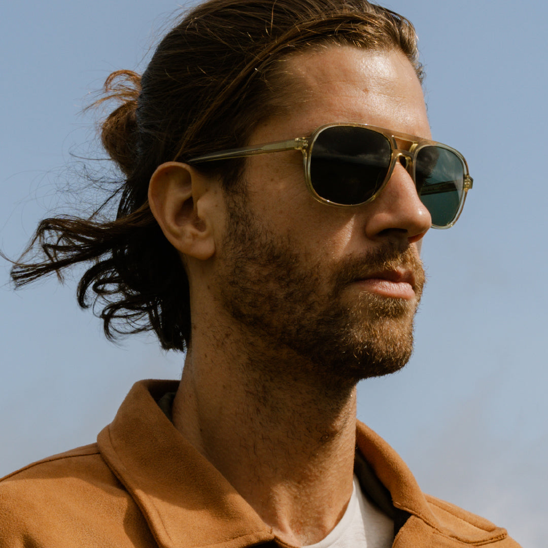 Man wears Howlin' sunglasses from VALLON in sage color
