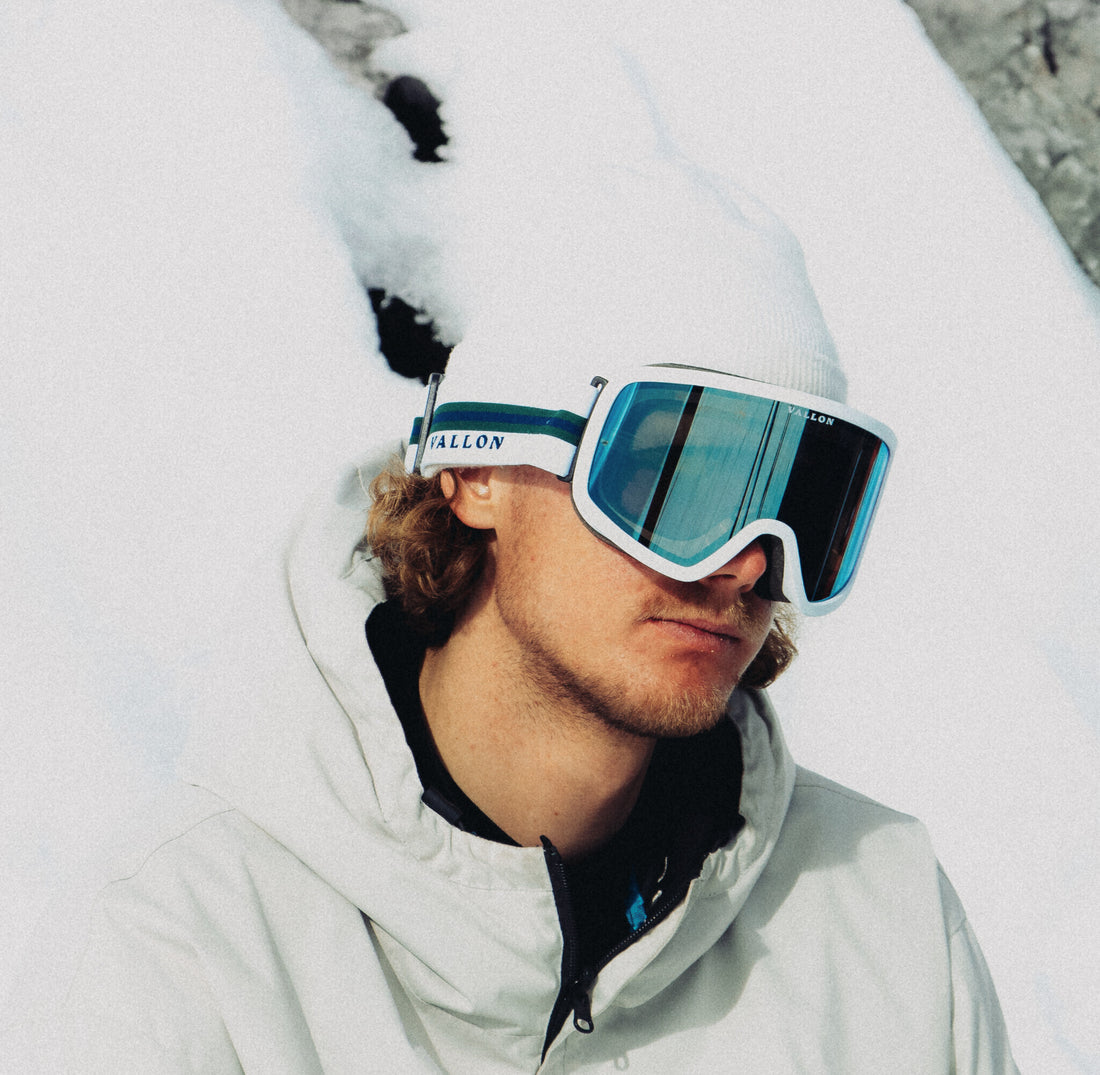 Man wears Stairways best 80s-inspired ski goggles from VALLON  in bright sunshine