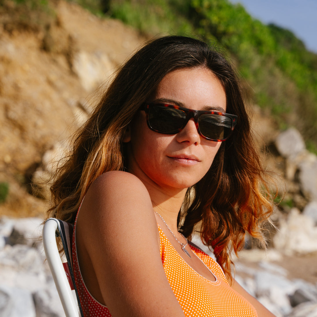 Woman wears Cat. 3 June sunglasses from VALLON for  day at the beach