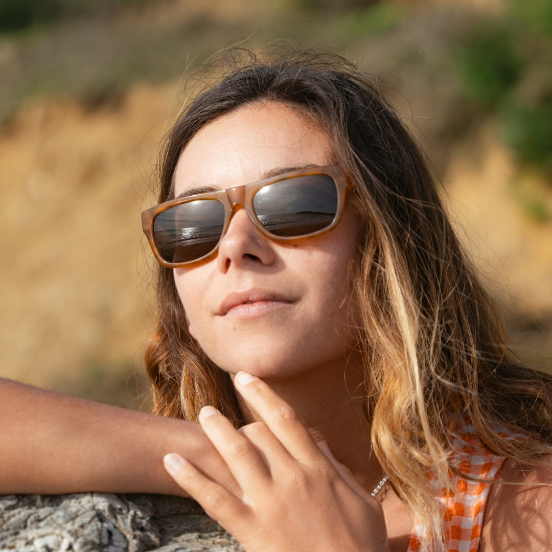 Woman wears June Cat. 3 women's rectangular sunglasses from VALLON with V52 optics