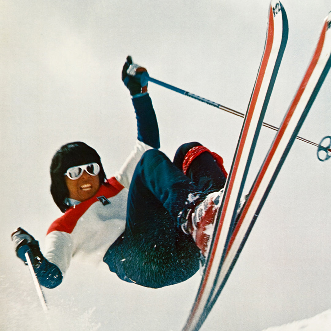 Wayne Wong wearing his iconic white Ski Aviators sunglasses skiing in 70s hotdogging style
