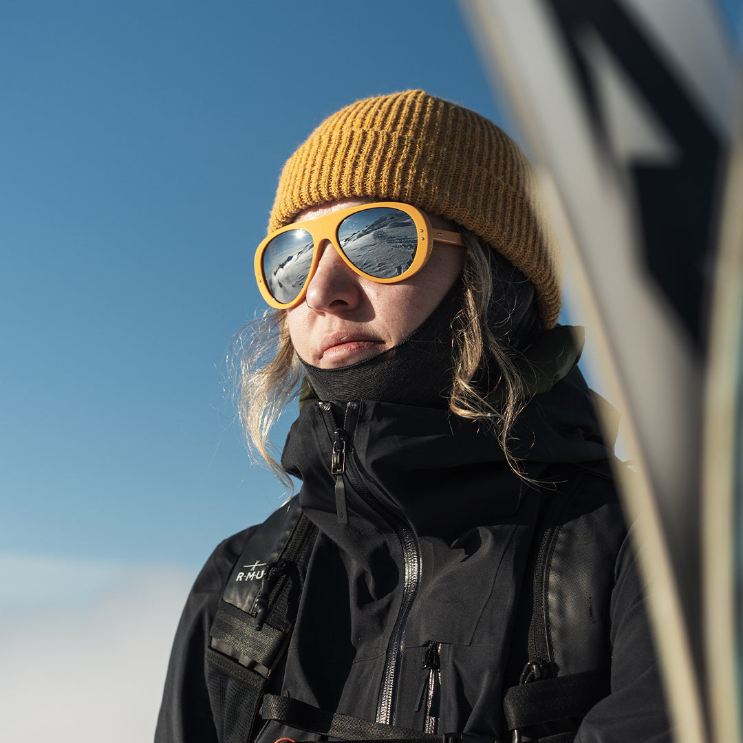 Woman wears 70s retro-inspired Ski Aviators in Yellow from VALLON