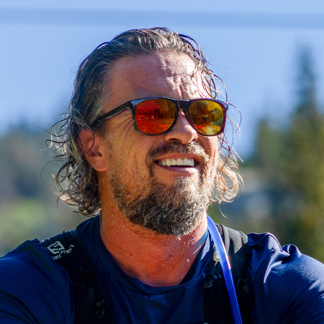 Man wears Ventures sports sunglasses in Brown-Orange with V52 optics and sustainable lightweight frame