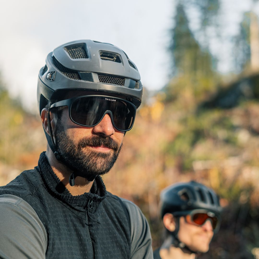 Male cyclist wears the VALLON Watchtowers, sustainable shield sunglasses for biking
