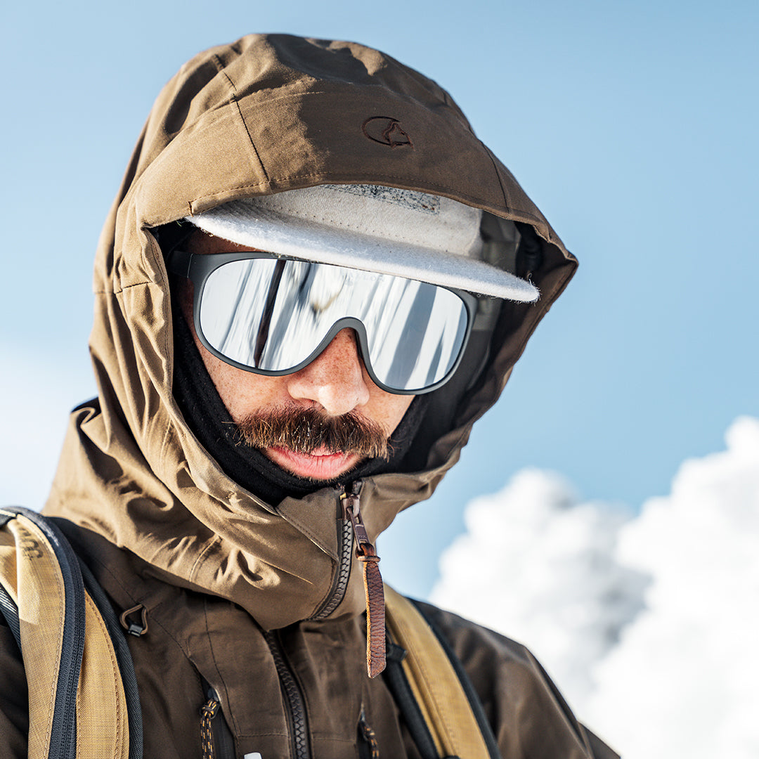 Man wears Dark-Grey-Silver shield sunglasses the Watchtowers from VALLON for ski touring