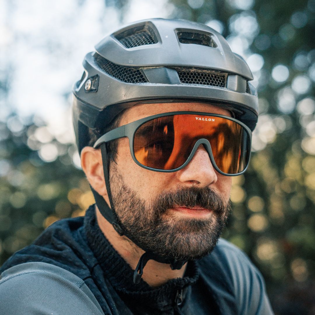 Male cyclist wears VALLON sustainable shield sunglasses the Watchtowers with ZEISS monolens