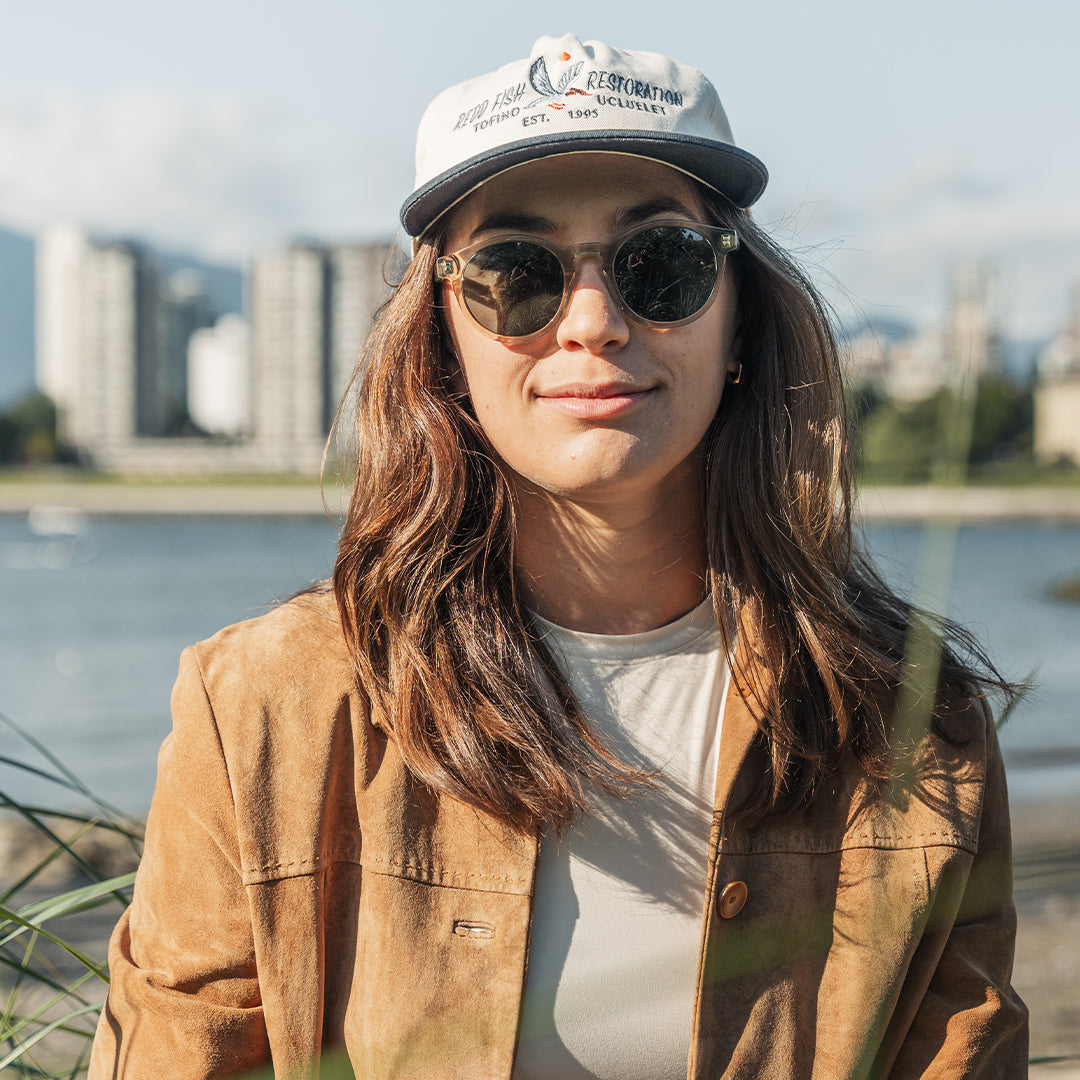 Woman wears VALLON Waylons round acetate sunglasses in Sage