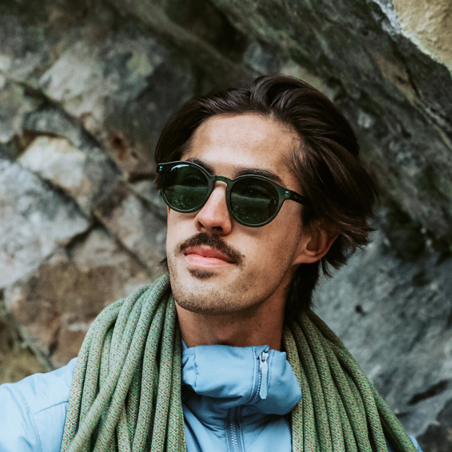 Male climber wears VALLON bestselling Waylons round acetate sunglasses in green