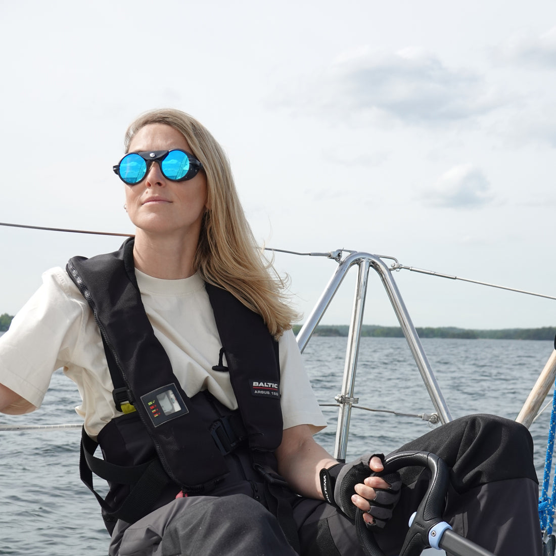 Female sailor wears Heron Ocean sunglasses from VALLON for open water sailing