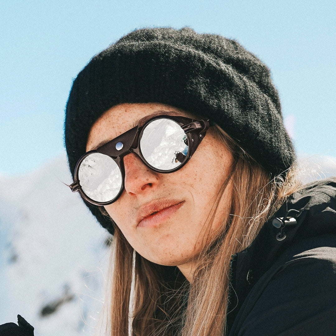 Woman wears Heron Glacier Cat. 4 side shield sunglasses from VALLON for ski touring