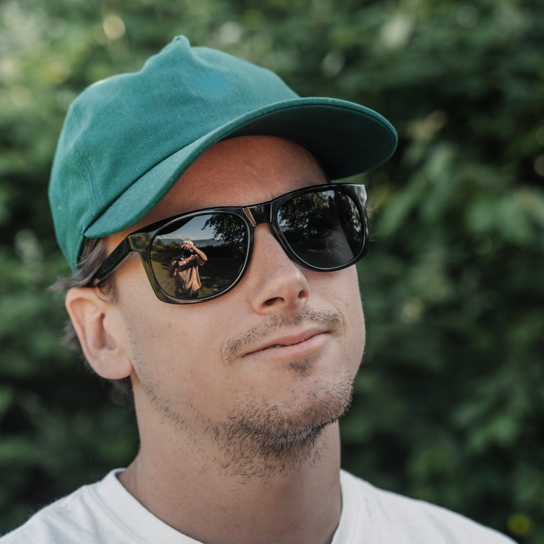 Man wears Ventures sustainable sunglasses from VALLON with V52 optics