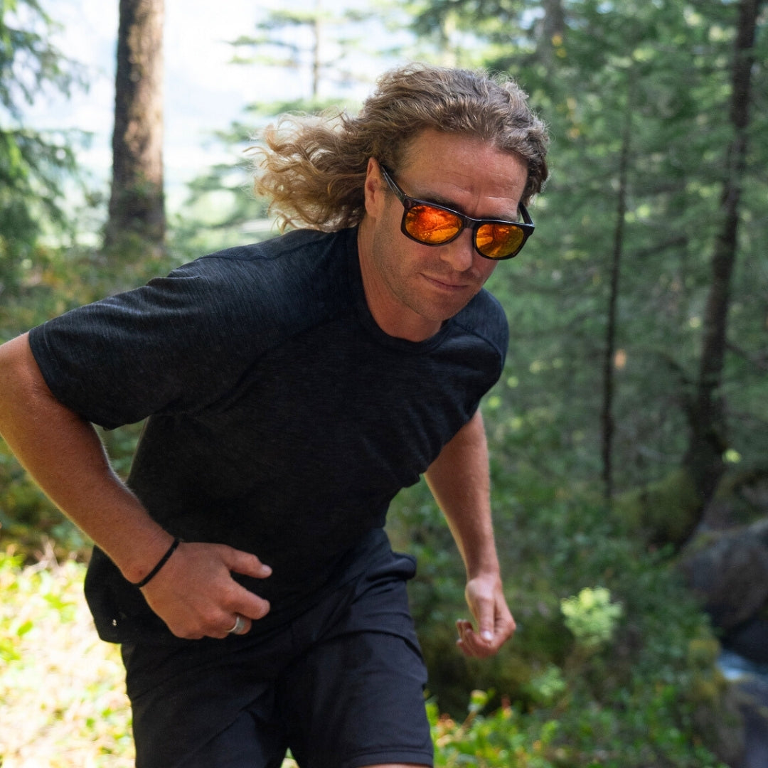 Male trail runner wears Ventures sports sunglasses in Brown-Orange with V52 optics and sustainable lightweight frame