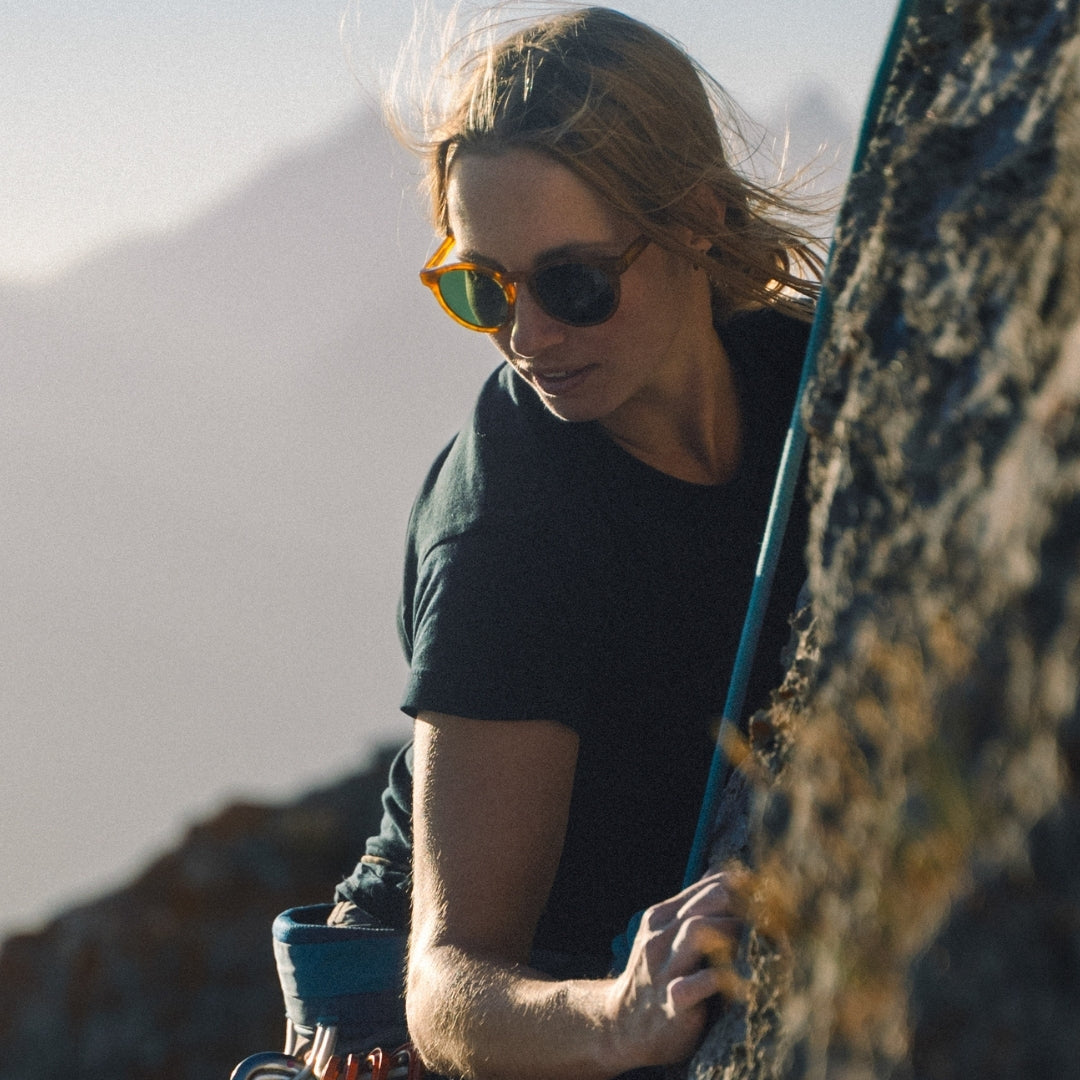 Female climber wears Waylons sunglasses from VALLON in Horn with premium acetate frame and V52 optics