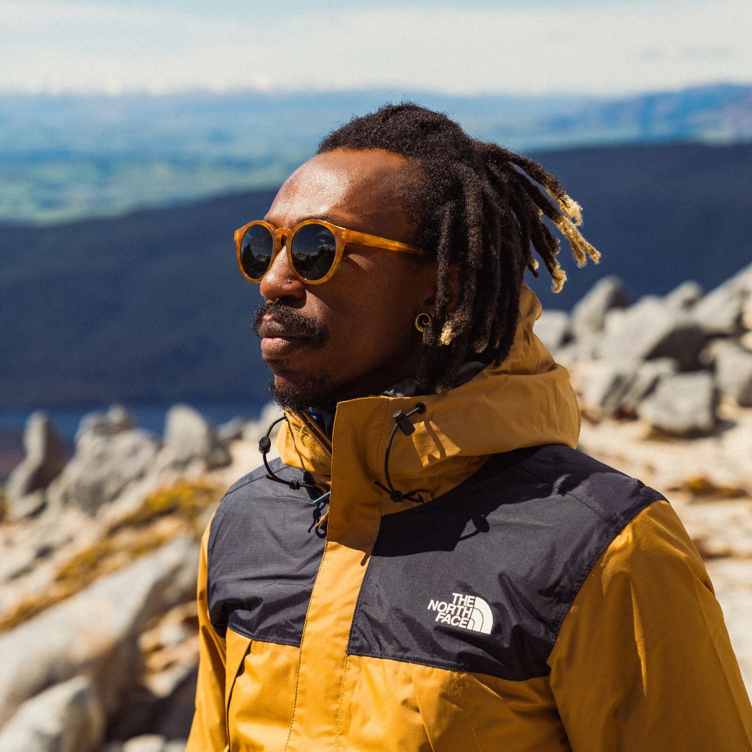 Man wears Waylons sunglasses from VALLON in Horn with premium acetate frame and V52 optics on rugged trail hike