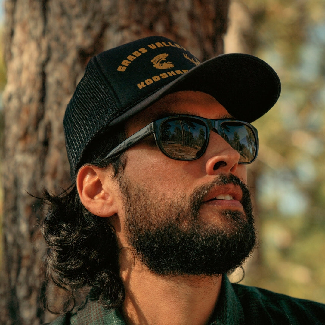 Man wears Wilburys acetate 50s-inspired sunglasses on a woodland trail