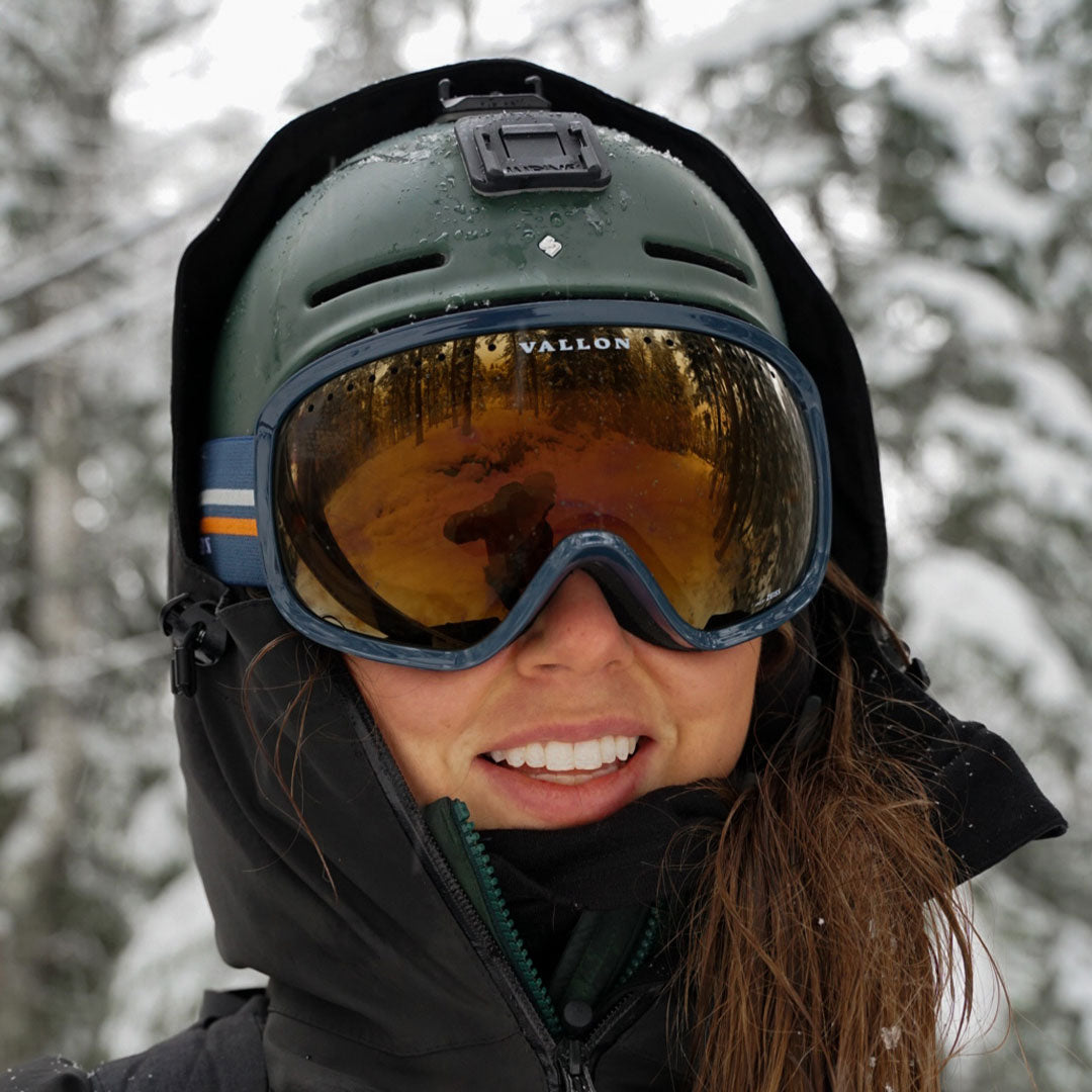 Woman wears Classic 80s-style Freebirds ski goggles from VALLON with helmet